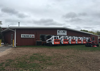 Skid loaders in front of C&K Equipment Sales Inc. building